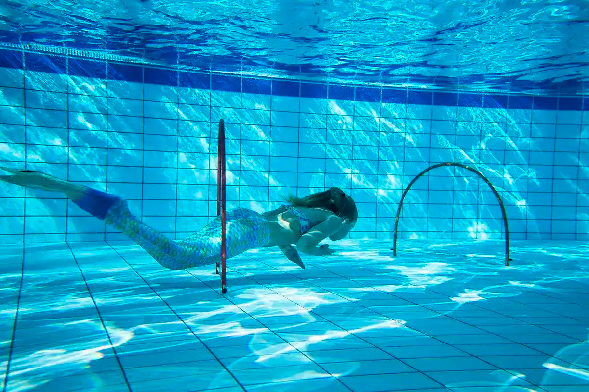 Mermaid Swimming lesson, girl in swimming pool with Ocean Queens Mermaid tail