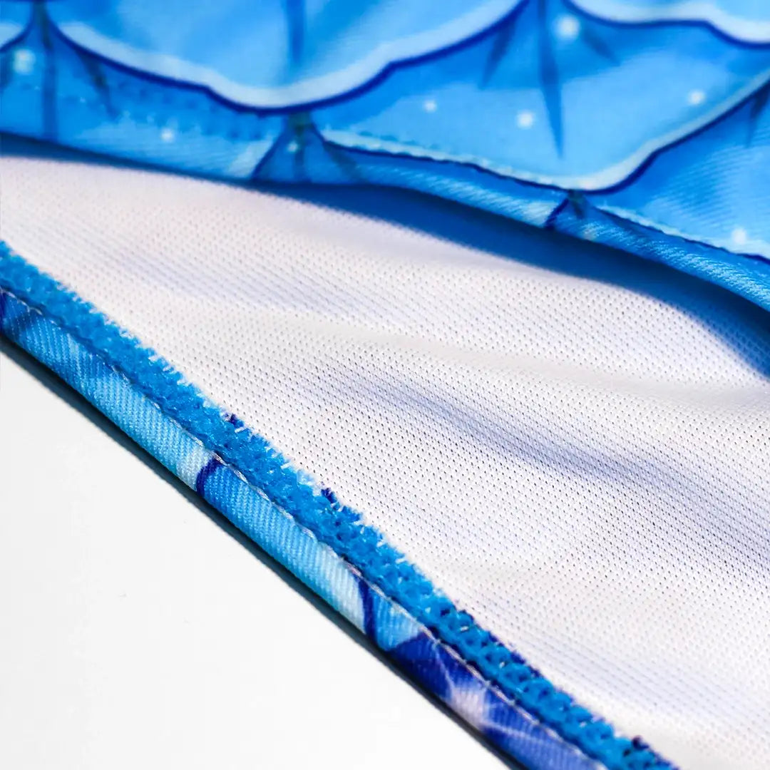 Zoomed view Studio product photography of Inner detail double layer Bikini bottom featuring a blue fish scales print, part of the Ocean Queens Galaxy Swim Brief collection