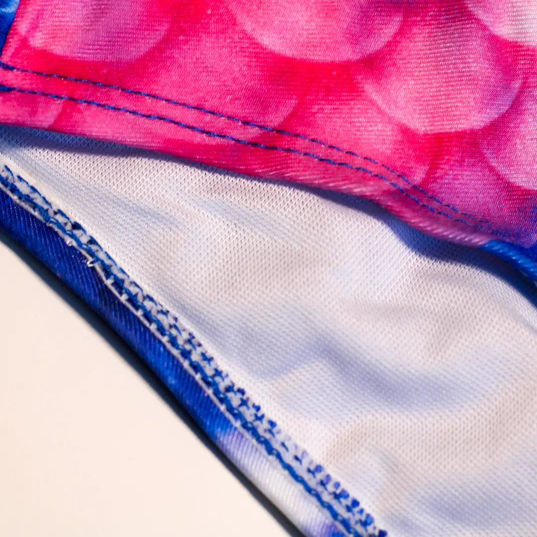 Zoomed view Studio product photography of Inner detail double layer Bikini bottom featuring a blue and pink galaxy fish scales print, part of the Ocean Queens Lunar Swim Brief collection