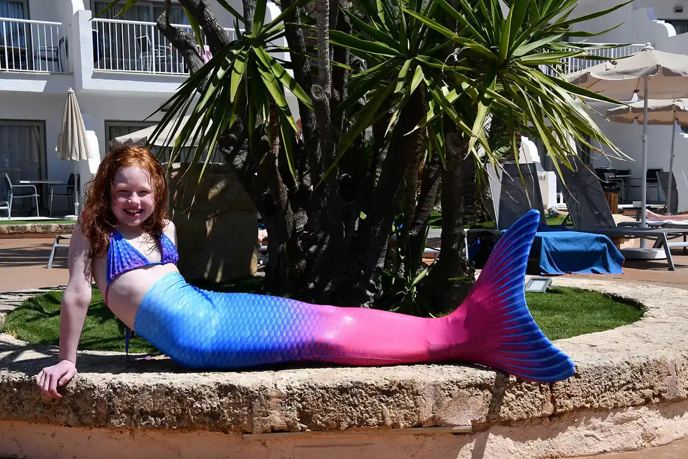 Real life photography Girl in Blue pink Maui mermaid tail with monofin, bikini top on the side of swimming pool - Ocean Queens