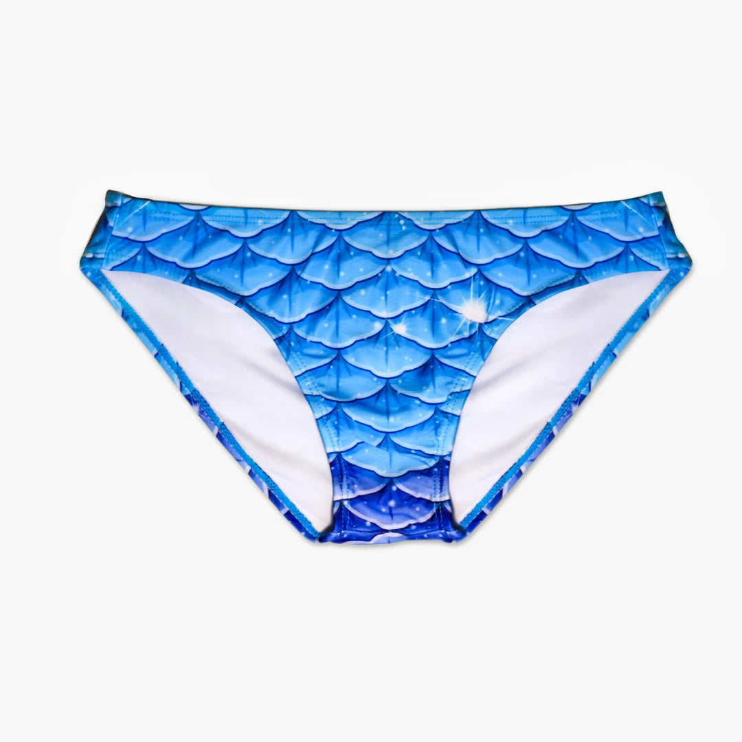 Front view Studio product photography of Bikini bottom featuring a blue fish scales print, part of the Ocean Queens Galaxy Swim Brief collection